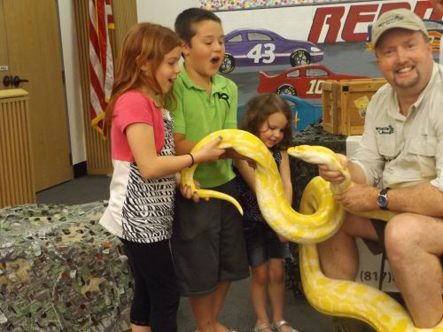 Kids holding a large snake